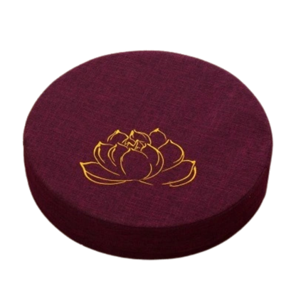 Round cushion with a gold lotus flower design on a white background