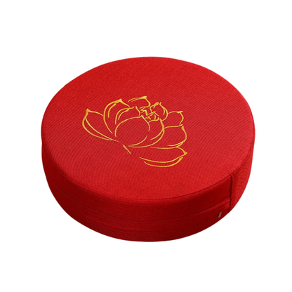 Red cushion with a gold lotus flower design on a white background