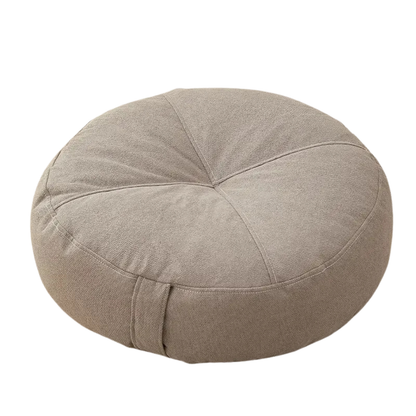 Round beige cushion on a white background