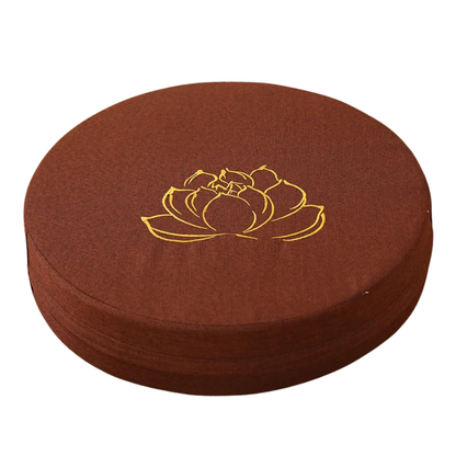 Round brown cushion with a gold lotus flower design on a white background