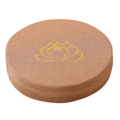 Round cushion with a yellow lotus flower design on a white background